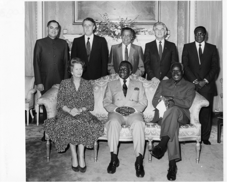 The 1986 Special London Summit of seven Commonwealth Heads of Government to consider further action, including sanctions against South Africa. Pictured: Back row, L to R – Rajiv Gandhi (India) ; Brian Mulroney (Canada); Sonny Ramphal (Commonwealth Secretary-General); Bob Hawke (Australia); Robert Mugabe (Zimbabwe). Front row, L to R: Margaret Thatcher (UK); Lynden Pindling (Bahamas – summit chair); Kenneth Kaunda (Zambia)