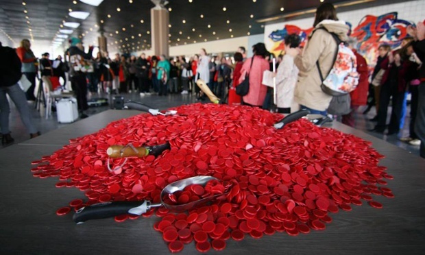 Members of the Women’s International League for Peace and Freedom redistribute red poker chips, symbolizing global military spending, as they see fit. Photograph: Mir Grebäck von Melen/WILPF via the Guardian