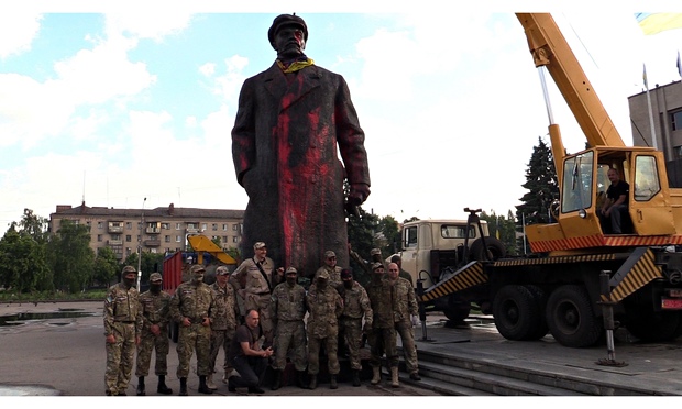 Ukrainian nationalists pose before the statue of Lenin in Sloviansk before tearing it down earlier this month. Photograph: Anadolu Agency/Getty Images