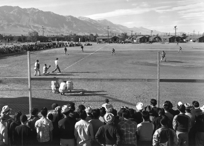 Japanese Americans play baseball at a WWII internment camp. Ansel Adams, "Baseball," 1943. Courtesy of Photographic Travelling Exhibitions.