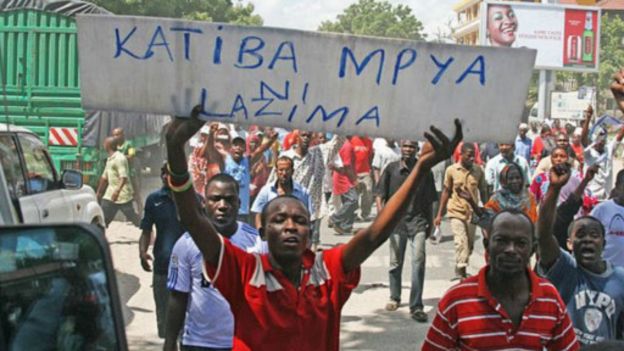 A CUF supporter holds up a placard: 'A new constitution is necessary'.