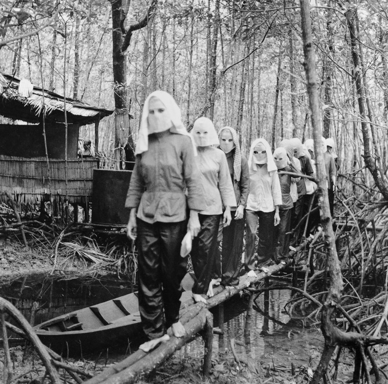 Activists meet in the Nam Can forest, wearing masks to hide their identities from one another in case of capture and interrogation. IMAGE: VO ANH KHANH/ANOTHER VIETNAM/NATIONAL GEOGRAPHIC BOOKS