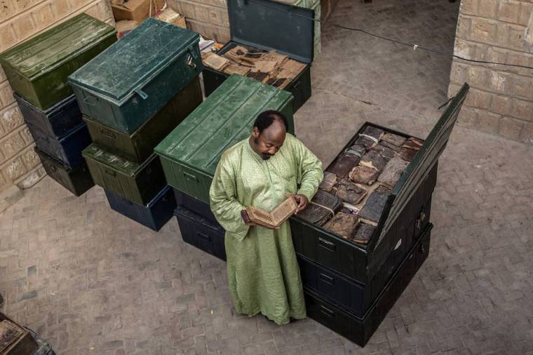 Abdel Kader Haidara with ancient family-owned manuscripts, Timbuktu, Mali, 2007. PHOTO: AMI VITALE/PANOS