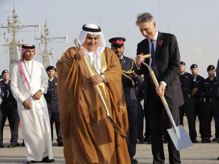 British Foreign Secretary Philip Hammond and Bahraini Foreign Minister Sheik Khalid bin Ahmed Al Khalifa, center help lay a cornerstone for a new British military base being built in Manama, Bahrain. AP Photo/Hasan Jamali
